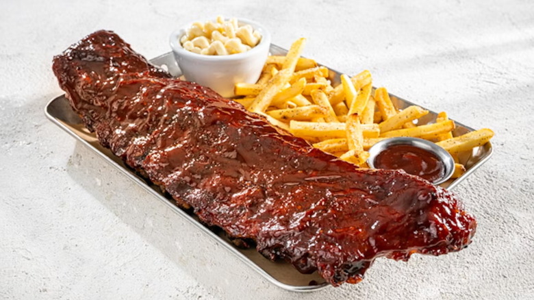 A full rack of baby back ribs with fries and mac 'n cheese.