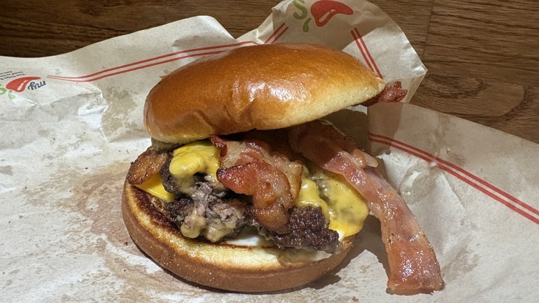 Bacon Cheeseburger with a large piece of bacon sticking out