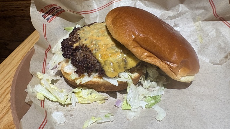 Big Smasher Burger with the top bun tilted off of the burger