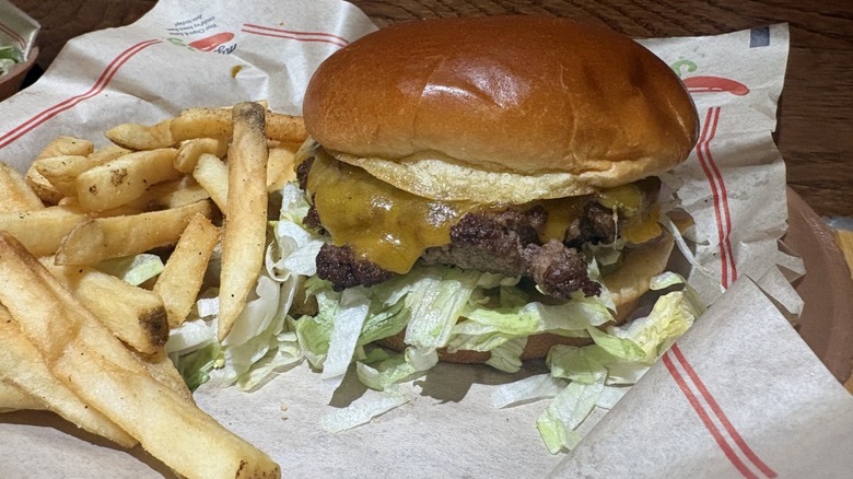 Oldtimer Burger W/ Cheese next to a bunch of French fries