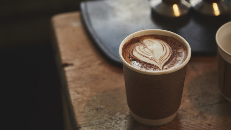 A mocha latte with foam shaped into a heart on top