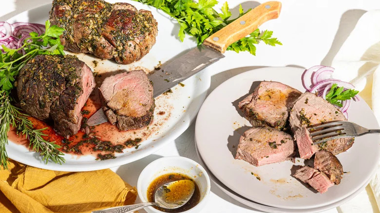 Beef tenderloin on a plate with greenery