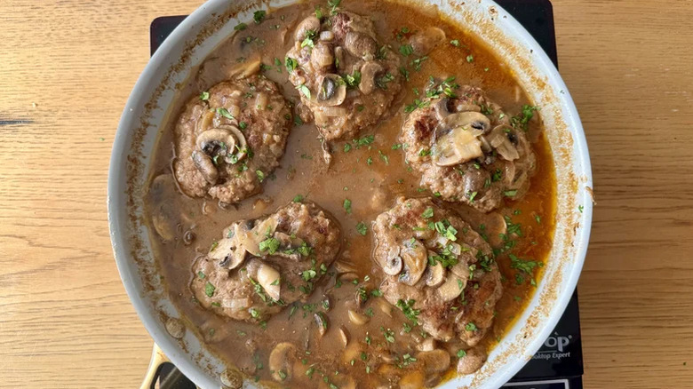 Salisbury steak in a pot with mushrooms