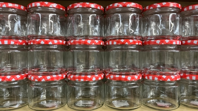 A stack of empty mason jars with lids