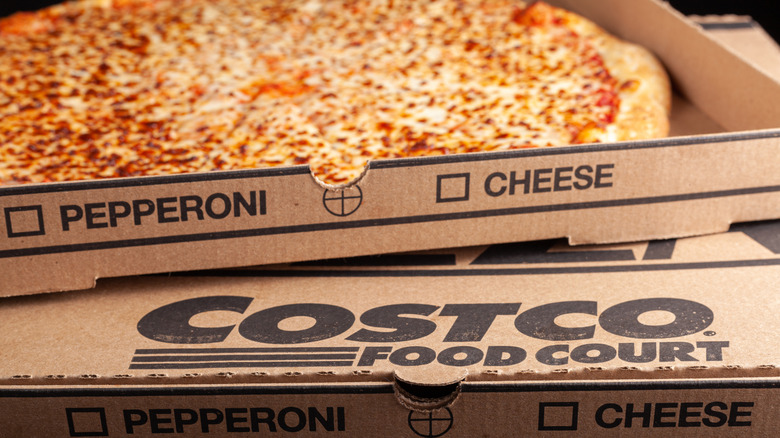 Side view of an open box of Costco cheese pizza