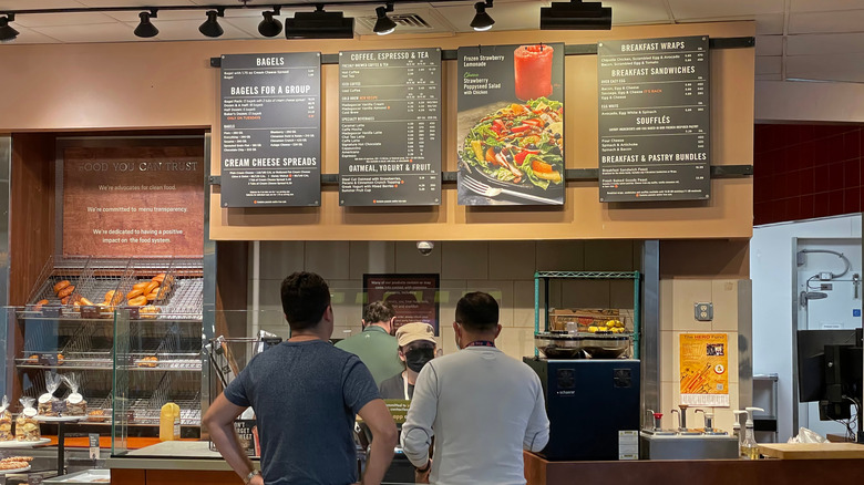 two customers ordering at the counter at a Panera Bread