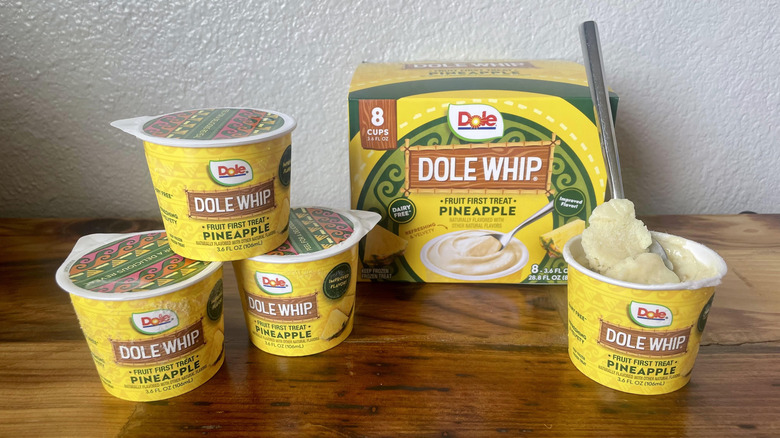 Several Dole Whip Pineapple Cups on a wooden table top