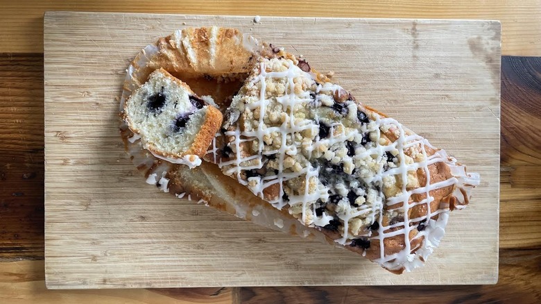 Overhead view of a Kirkland Signature Lemon Blueberry Loaf on a wooden cutting board