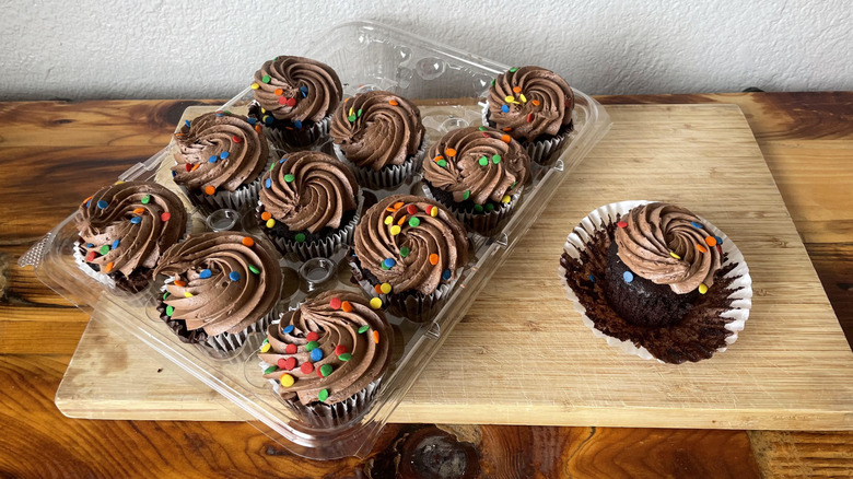 A package of Kirkland Signature Chocolate Cupcakes on a wooden cutting board