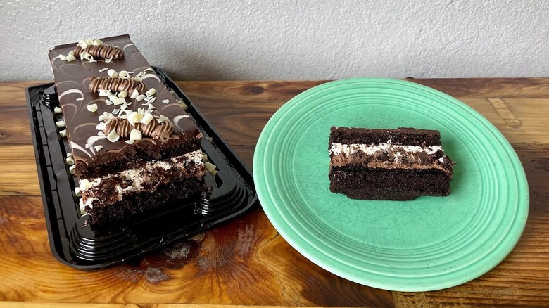 A Kirkland Signature Tuxedo Cake with a slice of it on a green plate