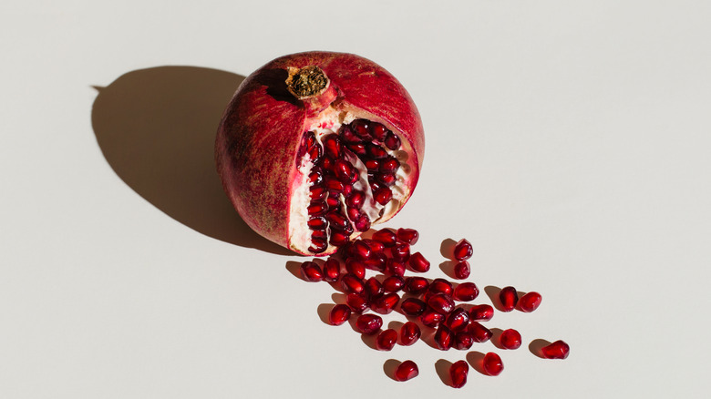 split open pomegranate on white background