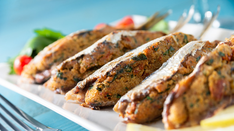 Stuffed sardines against a vibrant blue background