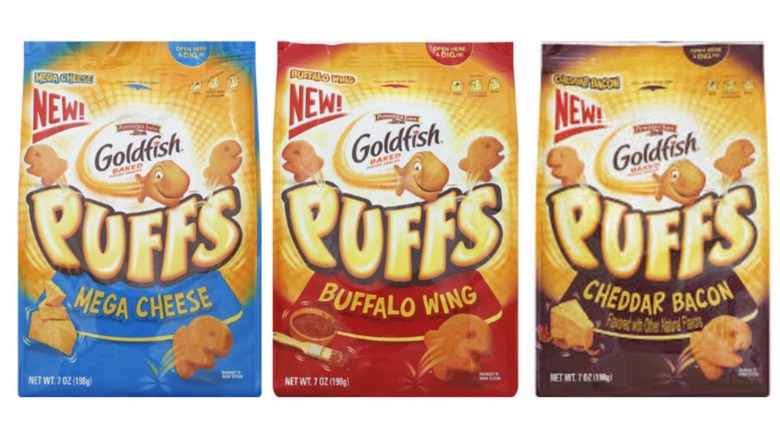 Three bags of Pepperidge Farm Goldfish Puffs baked snack crackers on a white background. The three flavors from left to right are Mega Cheese, Buffalo Wing and Cheddar Bacon.