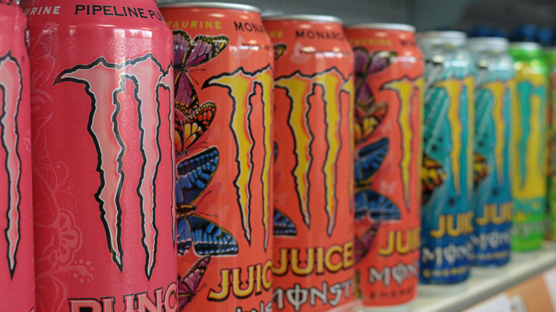 A row of multi-colored Monster cans