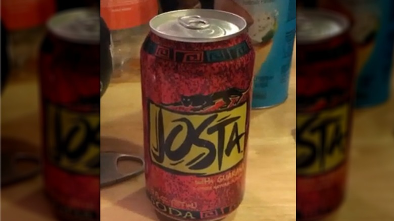 A closed can of Josta soda sitting on someone's desk
