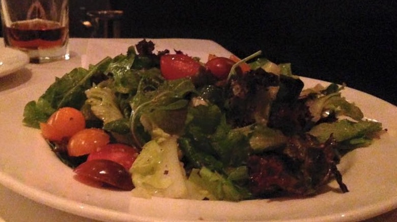 A slightly dark image of a Field Greens Salad from Capital Grille