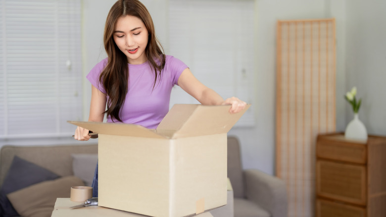 Woman looking inside an open cardboard box