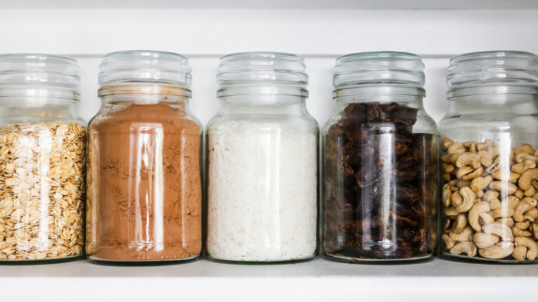 Matching clear jars full of food items on shelf