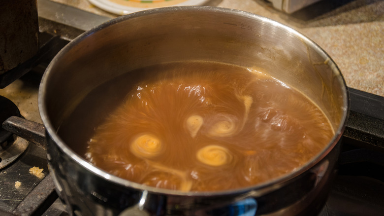Brown gravy simmering on stovetop