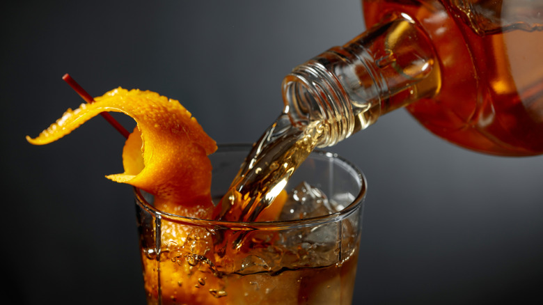 Bourbon being poured in cocktail glass