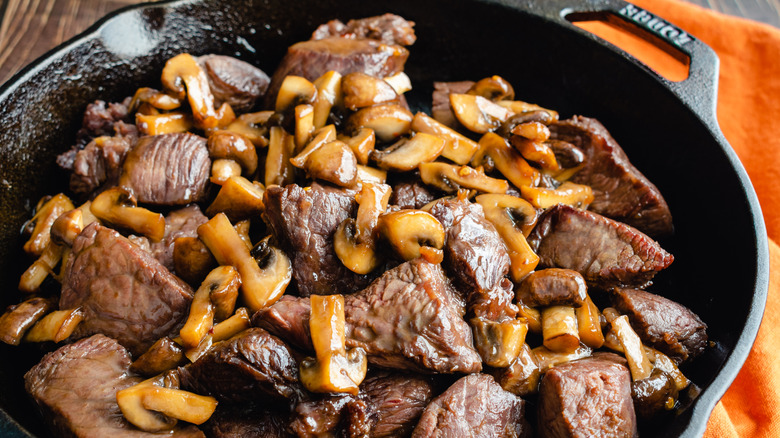 Bourbon steak tips and mushrooms in cast-iron