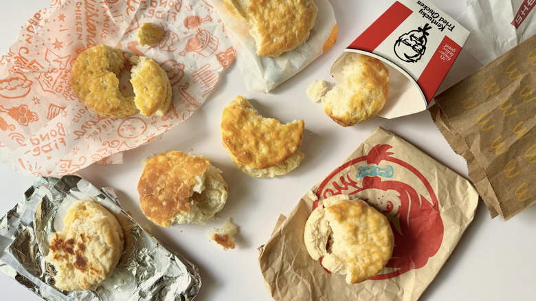 Assorted biscuits and their fast food packaging on a white surface