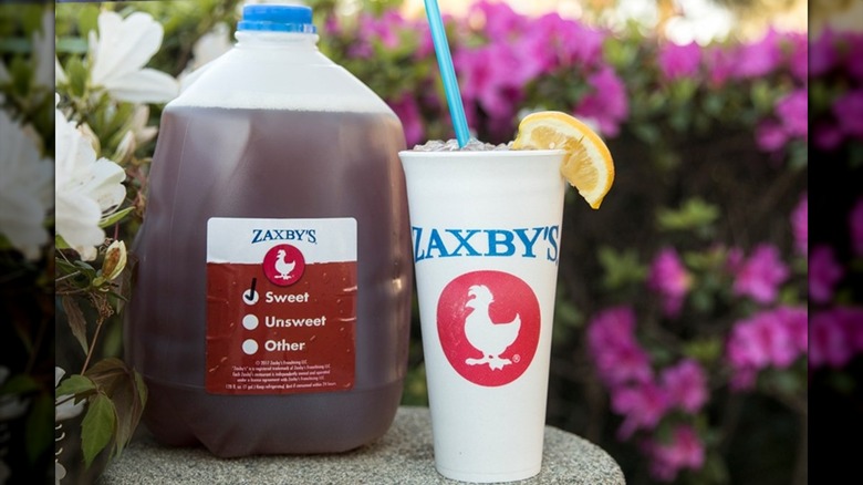 Zaxby's gallon sweet tea next to cup with lemon on rim