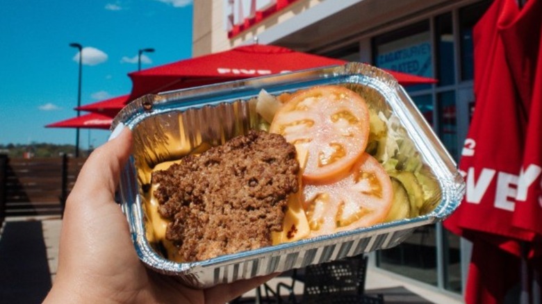 Close up image of a Five Guys burger bowl in an aluminum container.