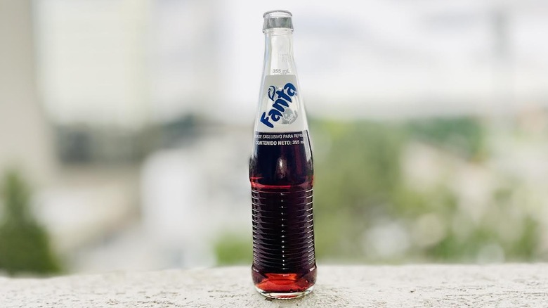 Bottle of Mexican Grape Fanta sitting on an outdoor ledge