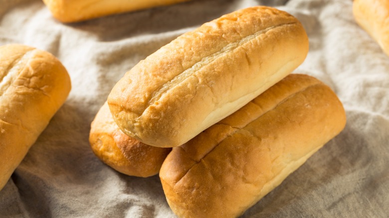 Italian sub rolls ready to have the bread scooped out