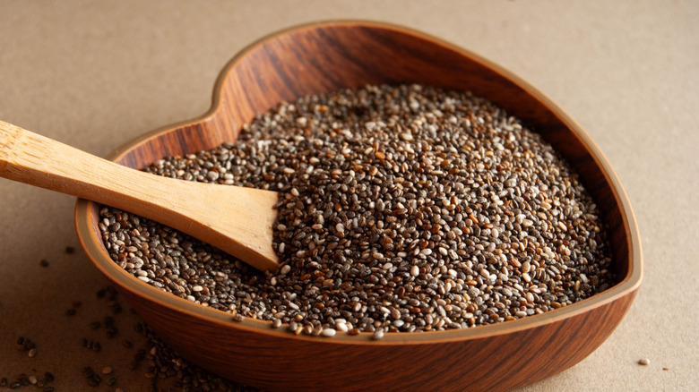 Chia seeds in a heart-shaped wooden bowl