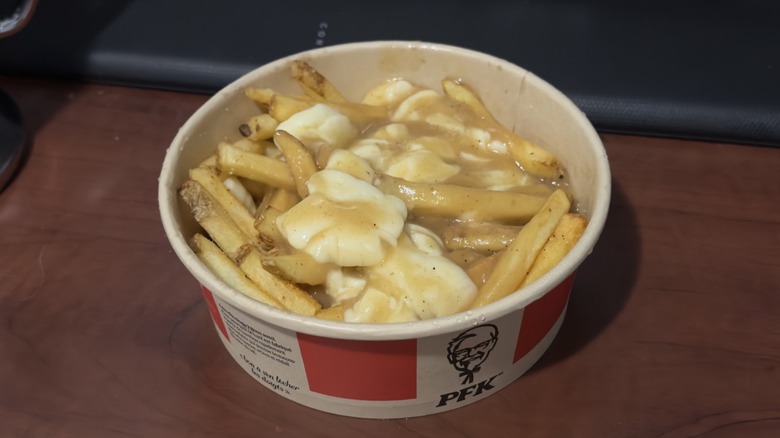 KFC poutine on a wooden surface