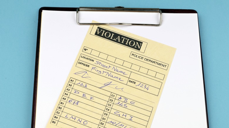 violation ticket on board with blue background