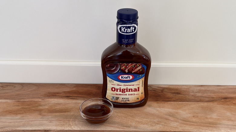 Kraft Original BBQ sauce bottle on cutting board next to dish of sauce