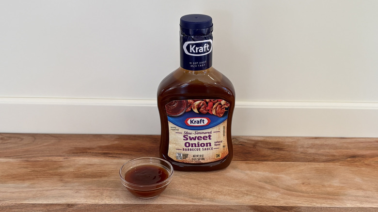Kraft Sweet Onion BBQ sauce bottle on cutting board next to dish of sauce