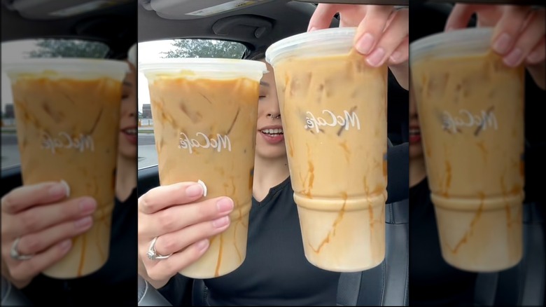 Two caramel iced coffees in McCafé coffee cups.