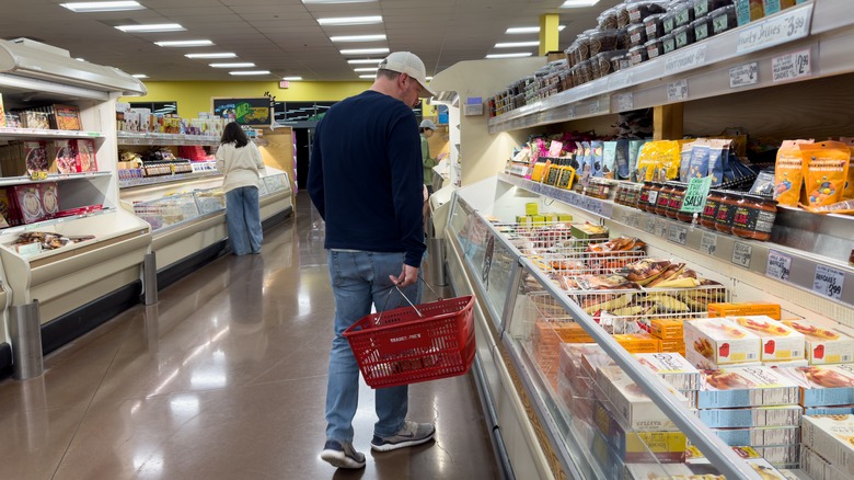 Man looking through frozen section at Trader Joe's