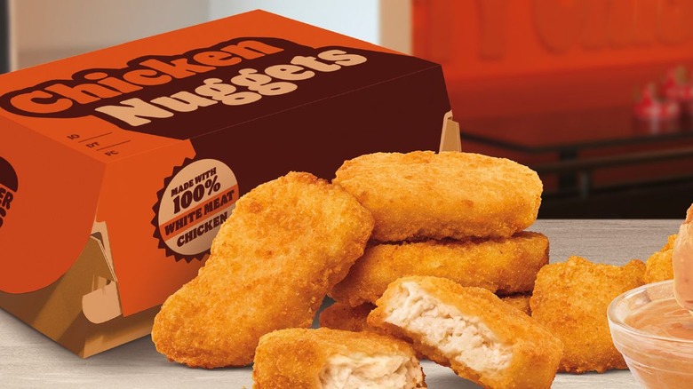 Chicken nuggets on a table with a Burger King cardboard box in the background.