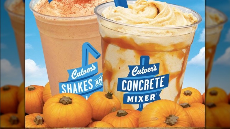 A Culver's concrete with caramel swirl and a Culver's shake with blue sky in the background and pumpkins in the foreground.