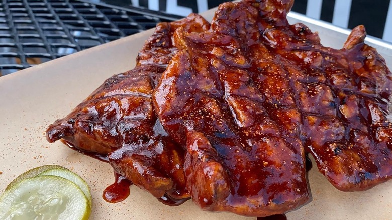 glazed barbecued snoots and pickles on brown parchment paper