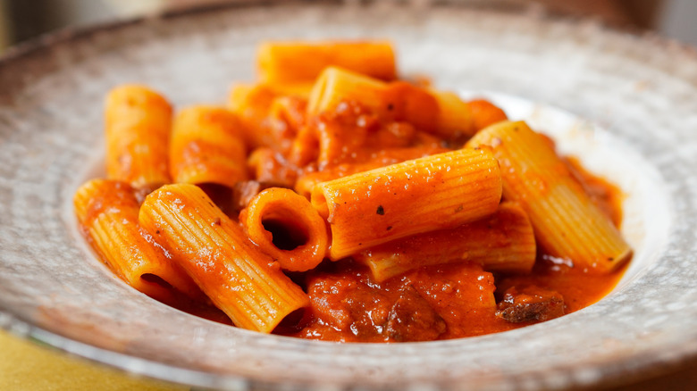 tomato-based pasta in modern bowl