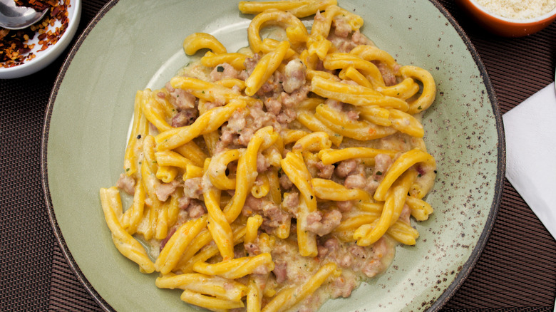 a plate of rabbit ragu on a green speckled plate