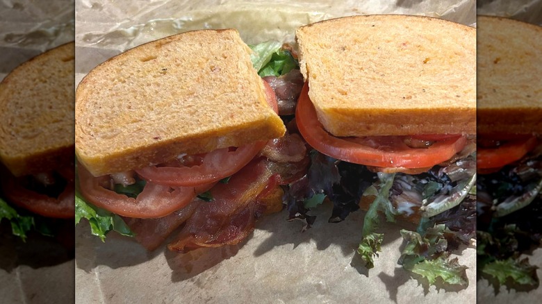 Tomato BLT sandwiches on parchment paper