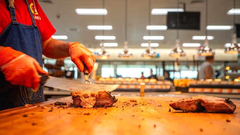Buc-ee's brisket sandwich being sliced by employee