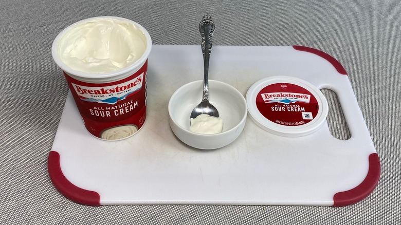 Breakstone's sour cream in a spoon alongside the packaging
