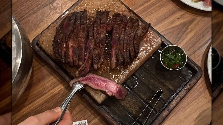 Slices of medium rare steak on a plate