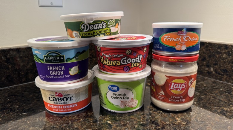 Seven French onion dip containers on countertop