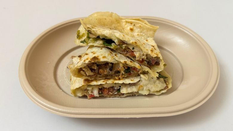 Moe's Chicken Club Quesadilla stacked atop each other on white table