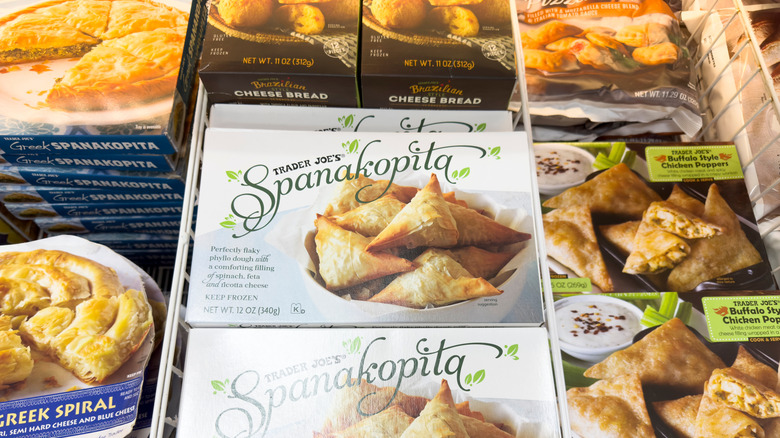 Frozen food boxes at Trader Joe's including Spanakopita and Greek spiral bread