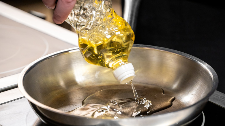 Pouring oil in a pan